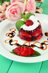 Tasty jelly dessert with fresh berries, on pink roses