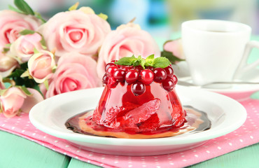 Tasty jelly dessert with fresh berries, on bright background