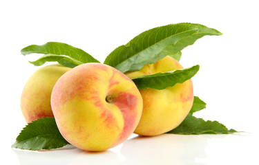 Ripe sweet peaches with leaves, isolated on white
