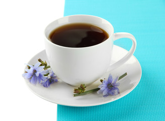 Cup of tea with chicory, isolated on white