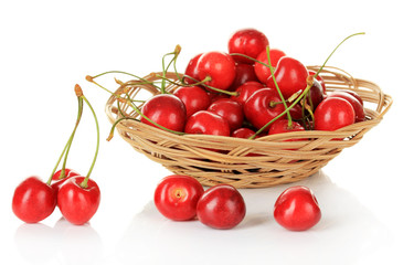 Cherry berries in wicker basket isolated on white
