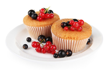 Tasty muffins with berries isolated on white