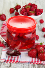 Home made berry jam on wooden table