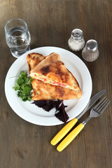 Pizza calzone on wooden table