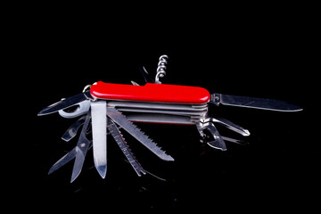 Swiss knife on black background