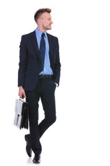 business man with suitcase and hand in pocket