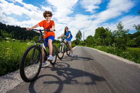 Healthy lifestyle - teenage girl and boy biking
