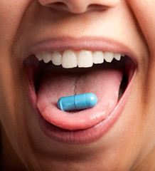 Young woman with a pill
