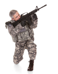 Mature Soldier Aiming With Rifle