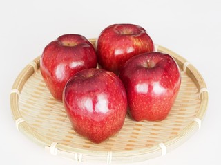 Apple in bamboo basket isolated on white background