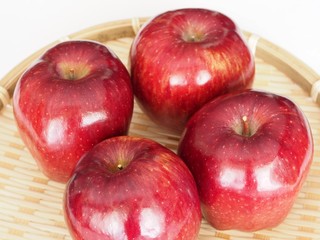 Apple in bamboo basket isolated on white background