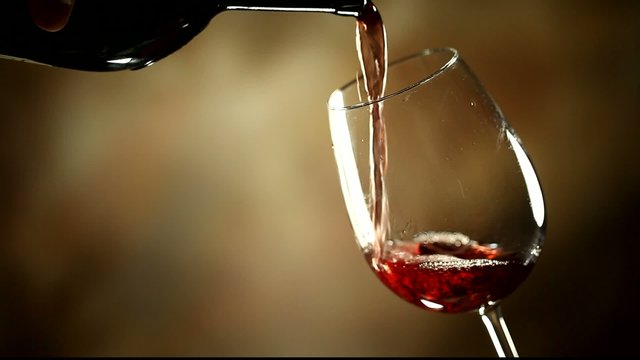 Pouring red wine into glass