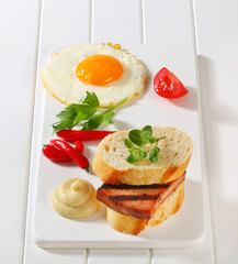Grilled Leberkase sandwich with mustard and fried egg