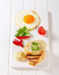 Grilled Leberkase sandwich with mustard and fried egg