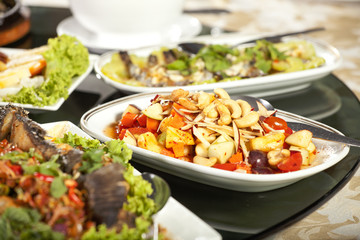 meal time, full round table with colorful food in restaurant