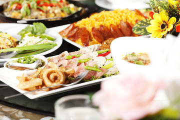 meal time, full round table with colorful food in restaurant