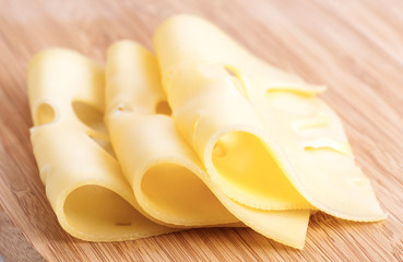 Leerdammer several slices of cheese on wooden board