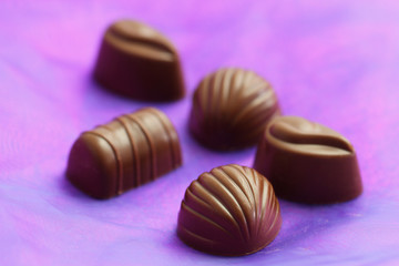 Milky chocolates on purple background