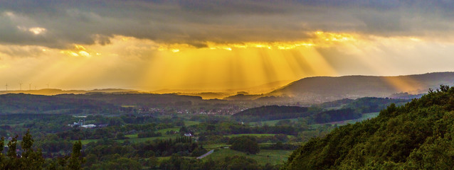 golden sunset at the  mountains of the saarland with dark rain c