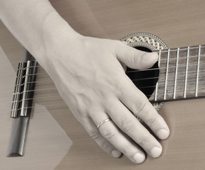 Hand on guitar strings