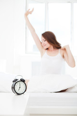 woman waking up and giving a stretch