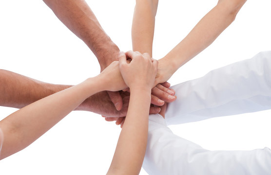 Group Of Doctors Stacking Hands Together