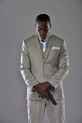 Man in suit with gun down in front