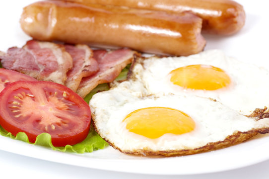 Breakfast with fried eggs with bacon and vegetables