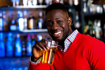 Guy drinking beer in a nightclub