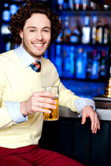Young man holding a glass of beer
