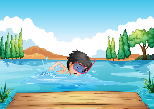 A boy swimming in the river with a pink goggle