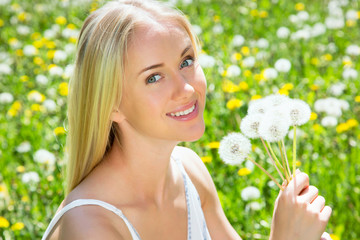 Woman among dandelions