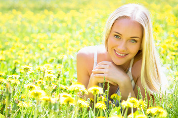 Beautiful young woman among the flowers