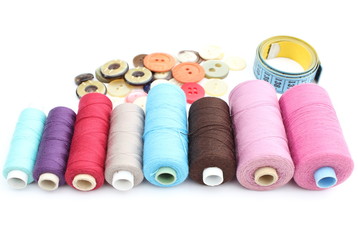 Colorful spools of thread, tape measure and buttons