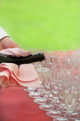 Waiter pouring champagne