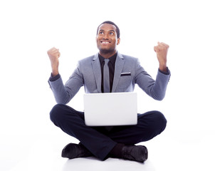 Successful business man with laptop and raised arms - isolated o