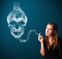 Obraz premium Young woman smoking dangerous cigarette with toxic skull smoke