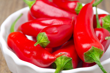 close-up of red hot chili peppers in  white bowl