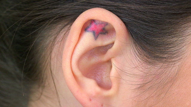 Extreme close up of tattoo in ear