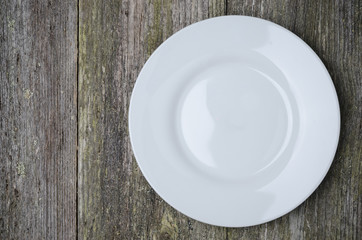 empty plate with space for text on old wooden background