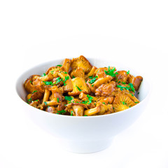Fried autumn golden chanterelle mushrooms with herbs in bowl