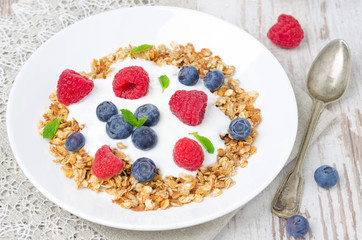 homemade granola with yogurt, raspberries and blueberries