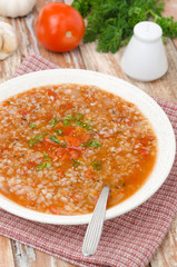 tomato soup with buckwheat groats in a plate vertical