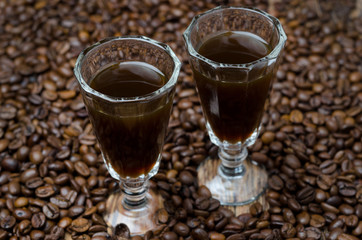 two shot glasses of coffee liqueur, selective focus