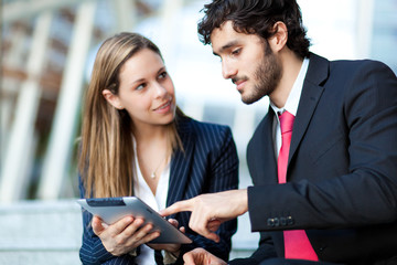 Portrait of two business people at work
