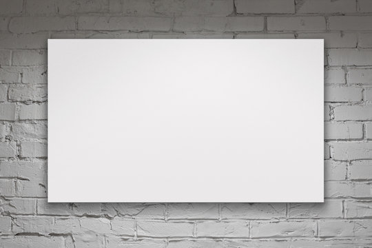 Image of blank billboard over white brick wall
