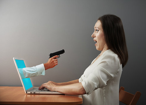 woman looking at hand with gun
