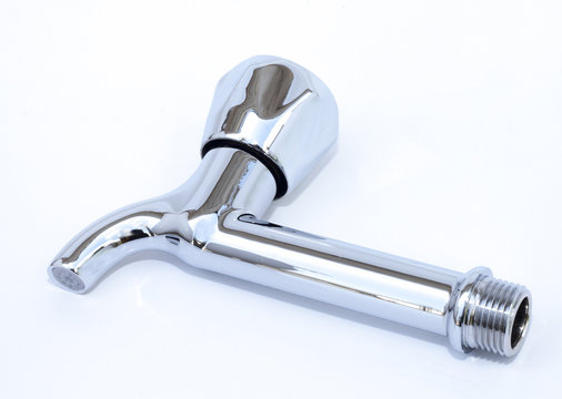 a new metalic faucet on a white background