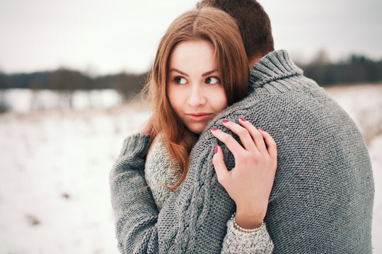 Winter outdoor forest portrait of young fashion couple in love
