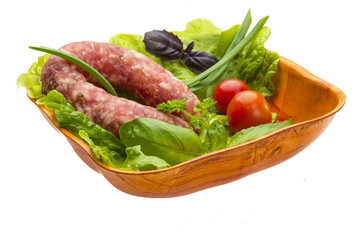 Ripe salami with salad, basil, onion and tomato